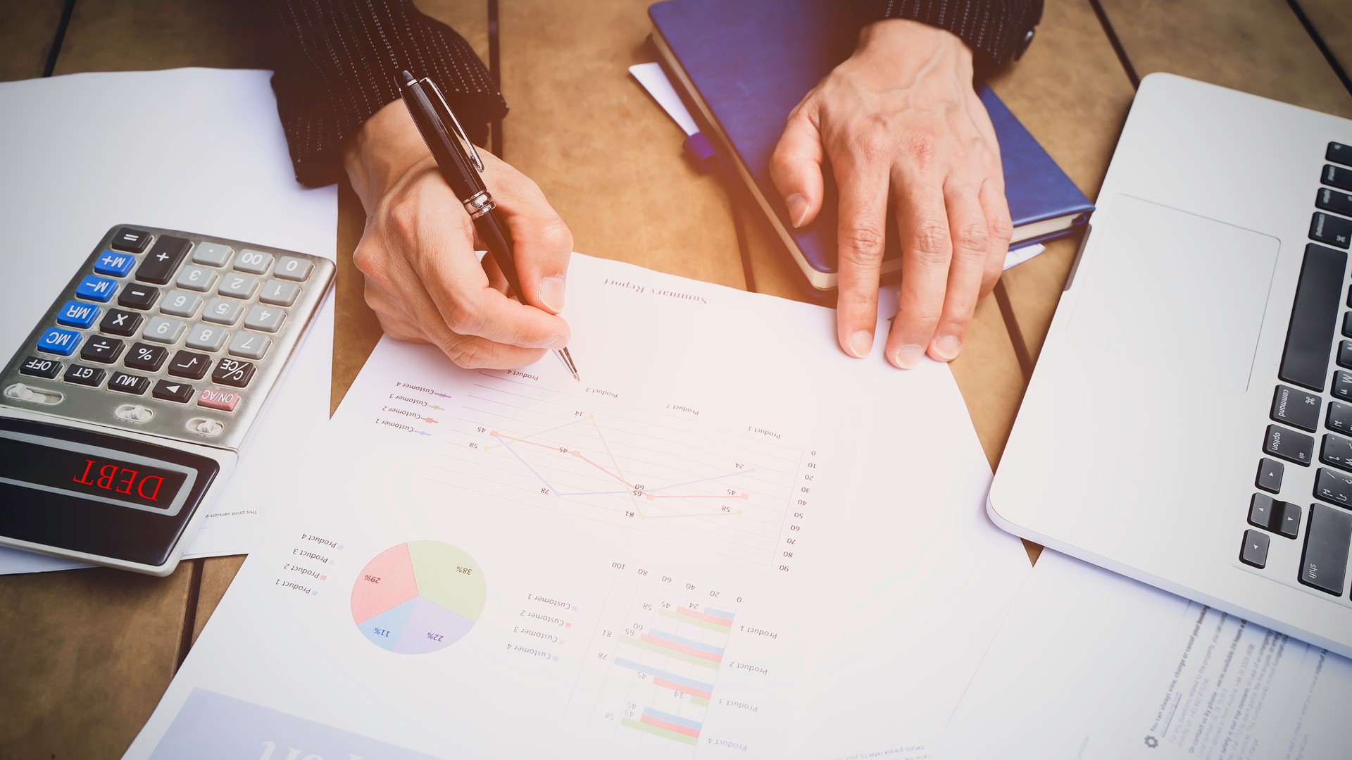 Selective focus man hand with pen check calculating the monthly of debt bills bank as a papers graph documents expenses and payment in the office